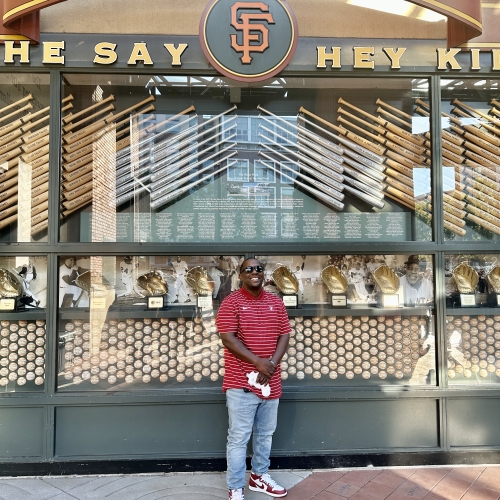 Albert Hughes standing in front of Willie Mays section in front of Oracle Park