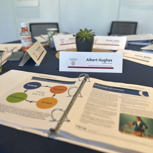 Albert Hughes’ name badge on the table in a conference room