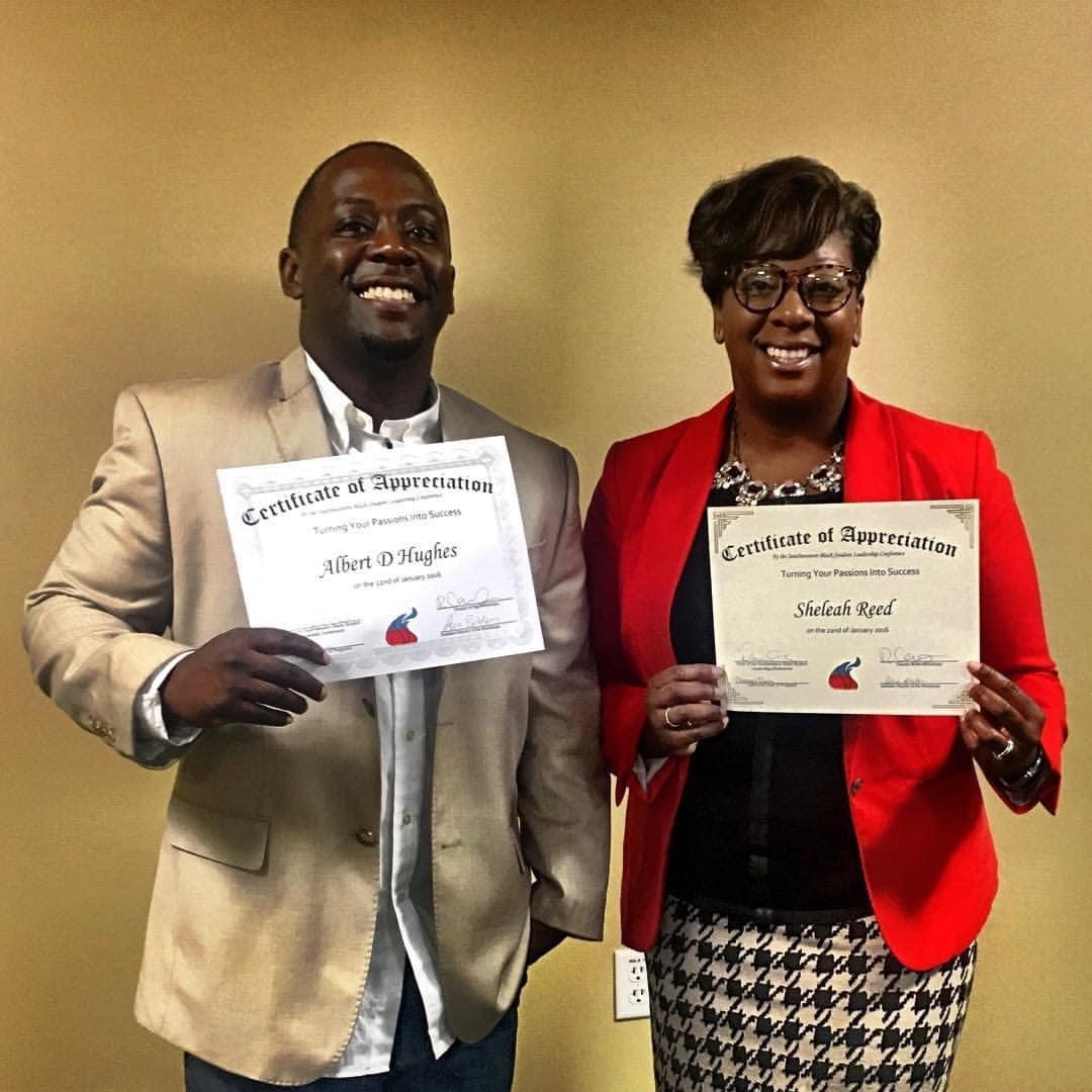 Albert D. Hughes III and Sheleah D. Reed holding certificates at